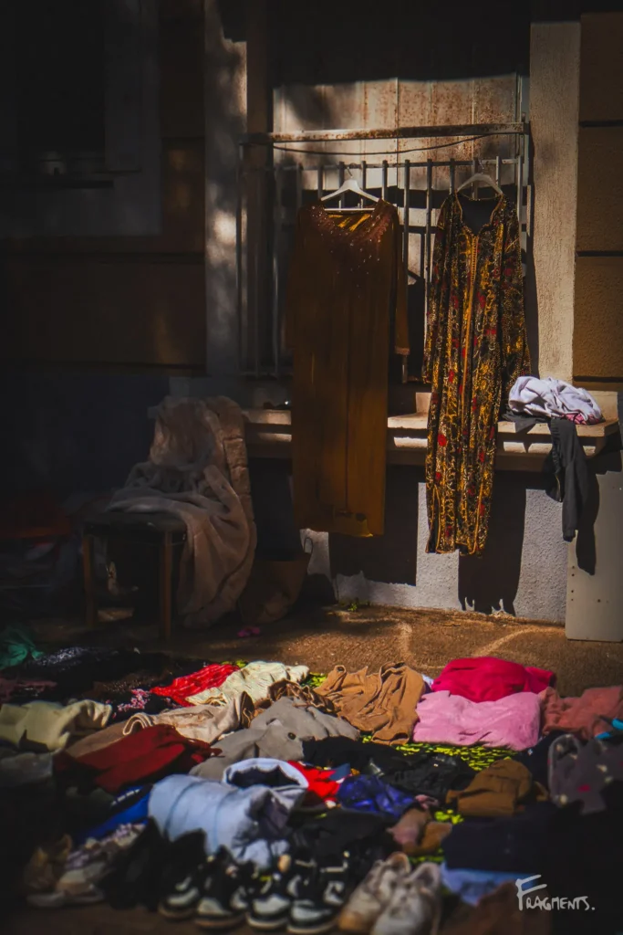 Photographie pour la page newsletter poétique mensuelle : Brocante avec étal de vêtements à Montpellier et jeu de lumières